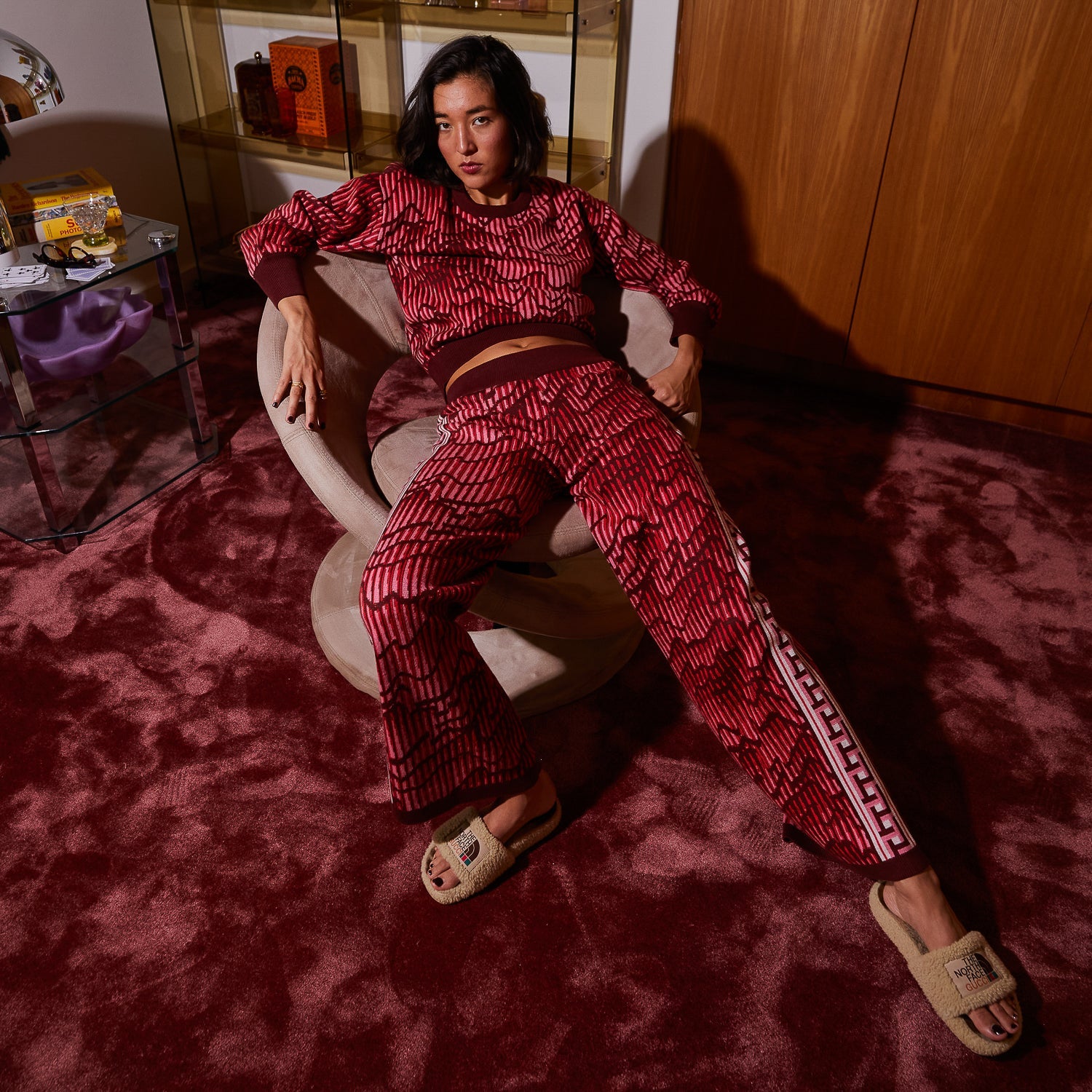 Lifestyle view of red geometric Hanna knit pants paired with neutral sleeveless top
