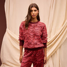 Front view of Hanna Knit Sweater with red geometric pattern and crew neck design