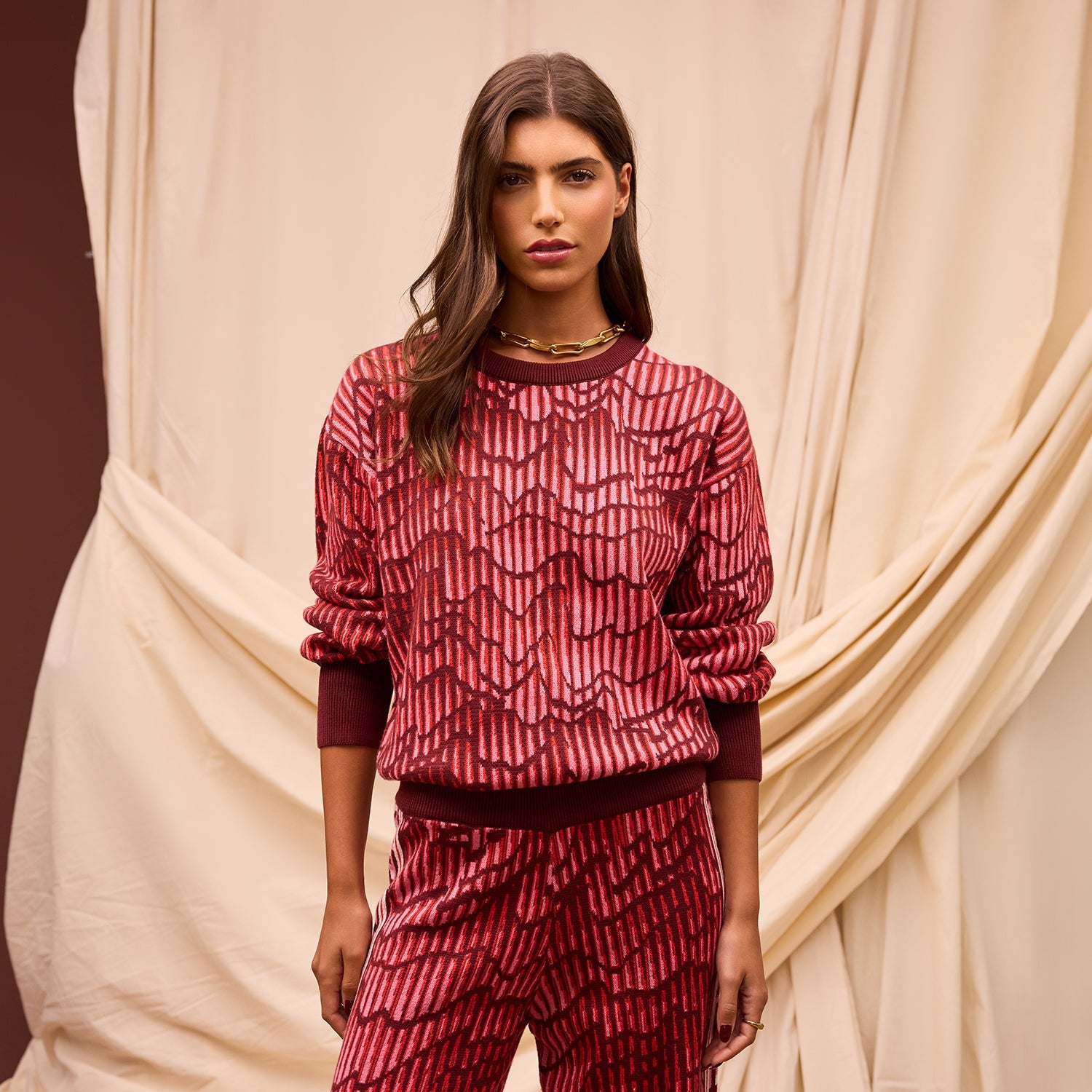 Front view of Hanna Knit Sweater with red geometric pattern and crew neck design