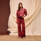 Full length view showing Hanna red knit sweater set with matching wide leg pants