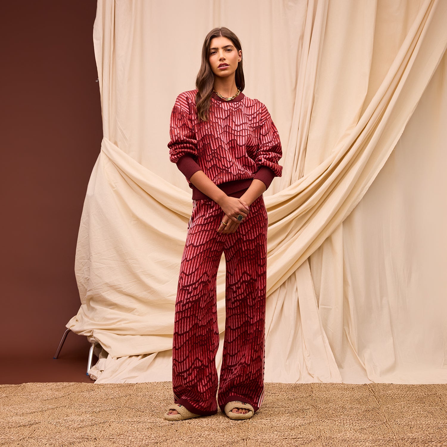 Standing front pose showcasing Hanna Kids Knit Sweater and coordinating patterned pants by Sage Clare