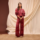 Standing pose of Hanna red geometric knit sweater with contrasting ribbed hem and cuffs