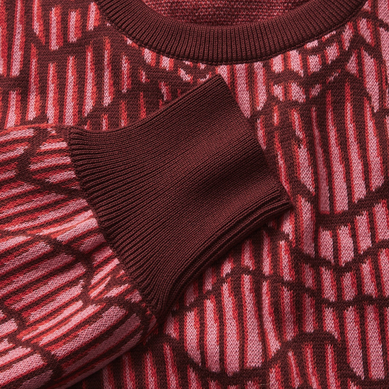 Fabric detail close-up of Hanna Knit Sweater showing red geometric knit pattern texture