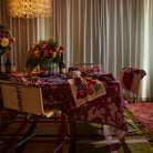 Detail view of Hanna Pansy napkin fabric texture showing pink zigzag stitching and colorful floral pattern