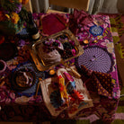 Dining table styled with Hanna Pansy napkins displaying floral pattern and zigzag stitched edges in tablescape
