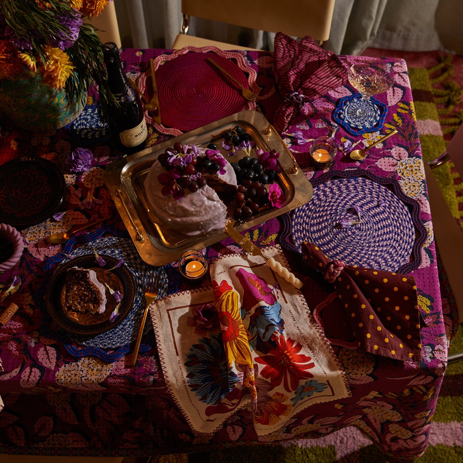 Dining table styled with Hanna Pansy napkins displaying floral pattern and zigzag stitched edges in tablescape