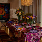 Aerial view of Hanna Pansy napkin set showing colorful floral patterns and zigzag stitched borders on table
