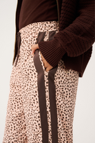 Close-up detail of Heidi Pant ocelot print fabric and brown side stripe construction