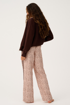 Back view of Heidi Pant in ocelot print showing wide leg silhouette and side stripe detail