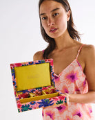 lady holding Kip & Co Jewellery Box while wearing Hibiscus Peach Adult Eco Satin Shorts & Cami Pyjama Set by Kip & Co