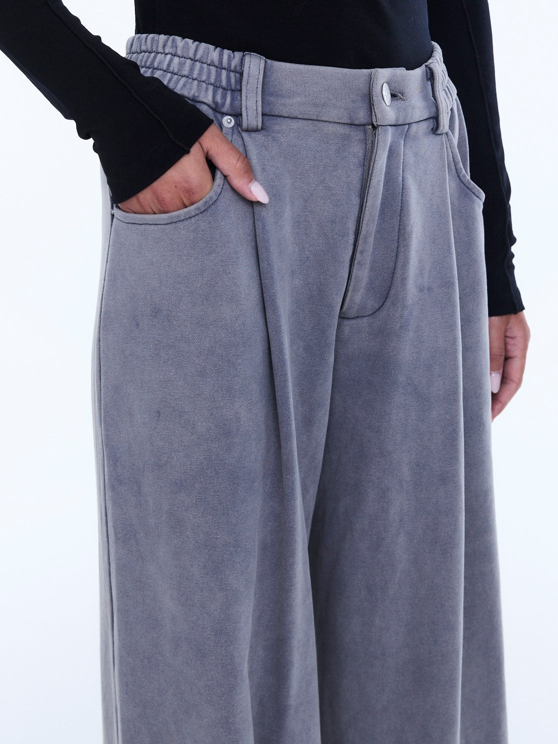 Close-up detail of dove grey jersey pant waistband showing elastic gathering and front pocket