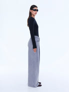 Side profile view of dove grey jersey wide leg pants showing relaxed fit and styling