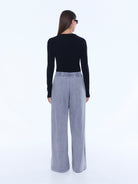 Back view of dove grey jersey wide leg pants showing elastic waistband and cuffed hem