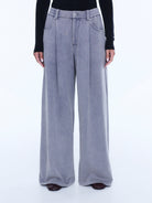 Front view detail of dove grey jersey pants showing button closure and wide leg silhouette