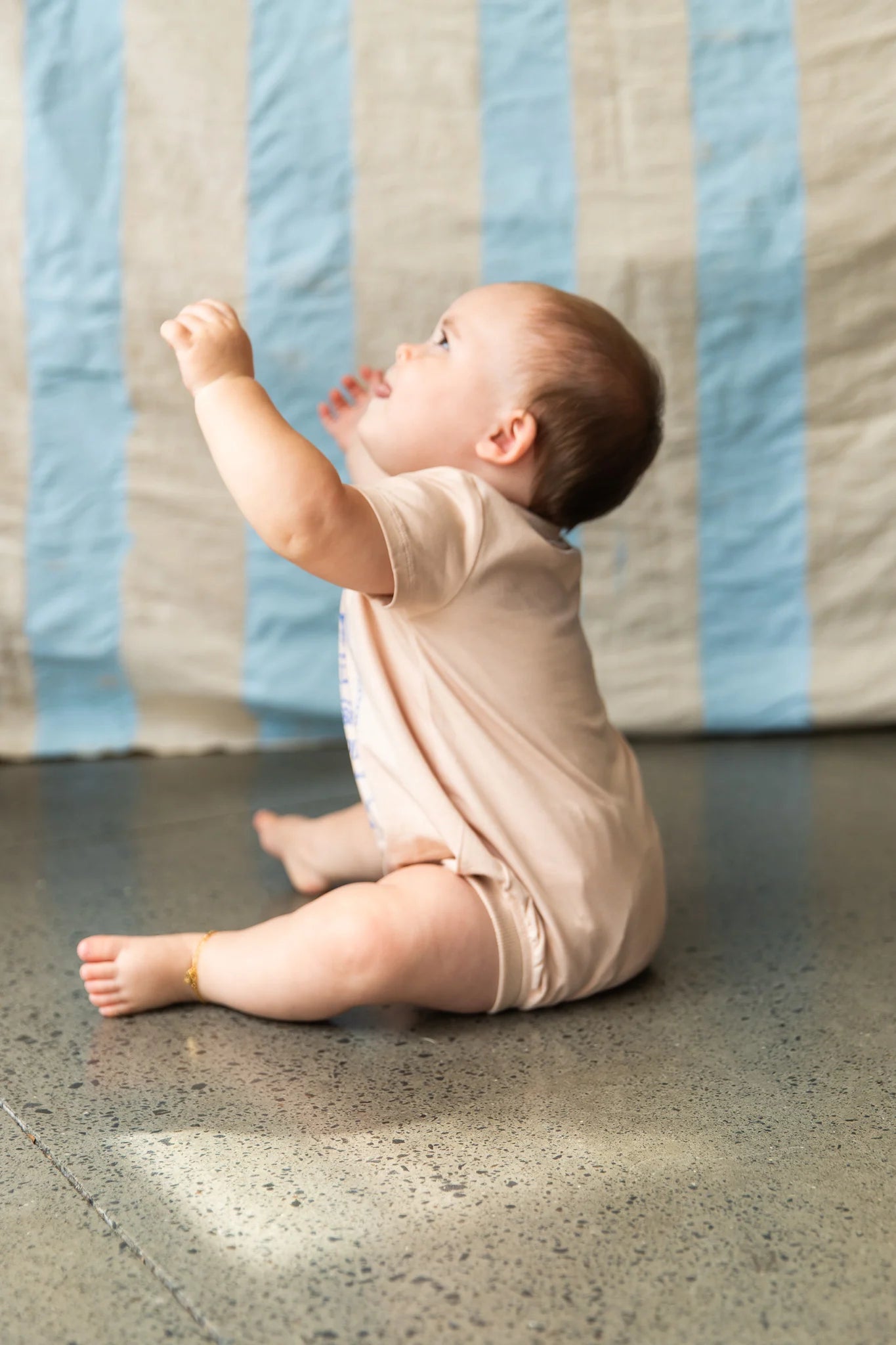 baby wearing cream coloured onesie by Pearson and Pearson ( Formerly Bella & Lace ) 