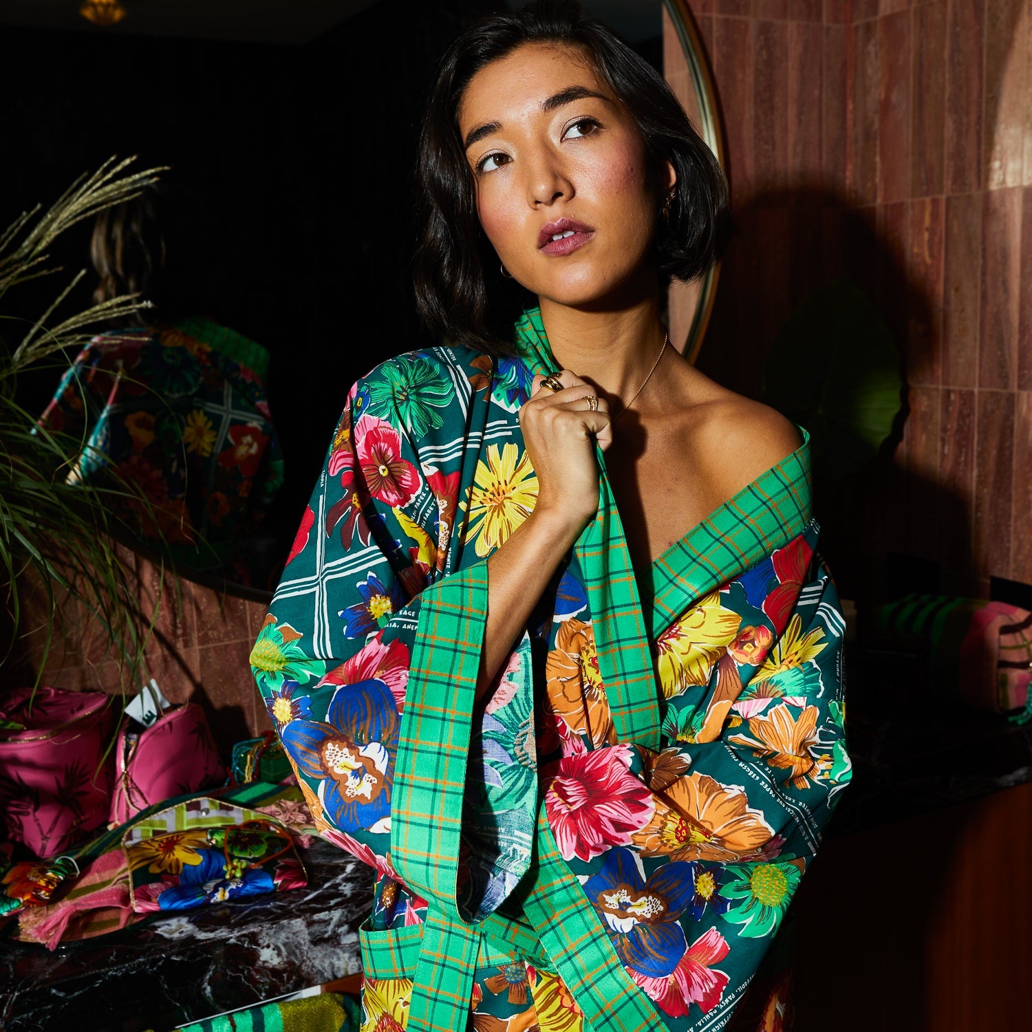Model wearing Ines Cotton Robe by Sage and Clare with colorful floral print and wide bell sleeves
