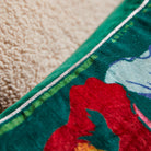 Corner detail of Ines Velvet Cushion Verdant showing piped edge trim and luxurious velvet fabric finish