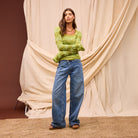 Flared sleeve construction detail on juniper merino wool knit top