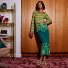 model wearing juniper green merino knit top displaying fitted silhouette and sleeve shape