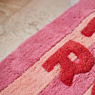 Pink and red bath mat by Sage and Clare