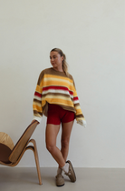 Standing view of Isabel Knit autumn stripe sweater showing full length and relaxed oversized silhouette
