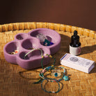 Orchid purple marbled cloud dish styled with rings and crystals on a woven rattan tray