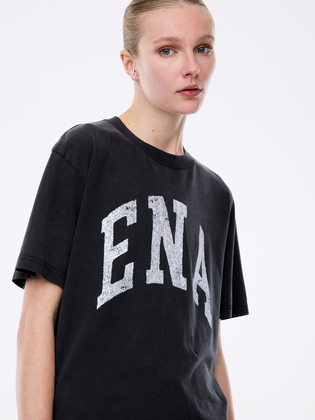Close-up front view of Jessie oversized tee in charcoal with white collegiate ENA graphic print