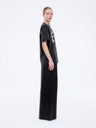 Side profile view showing oversized fit and dropped shoulders of Jessie collegiate tee in charcoal