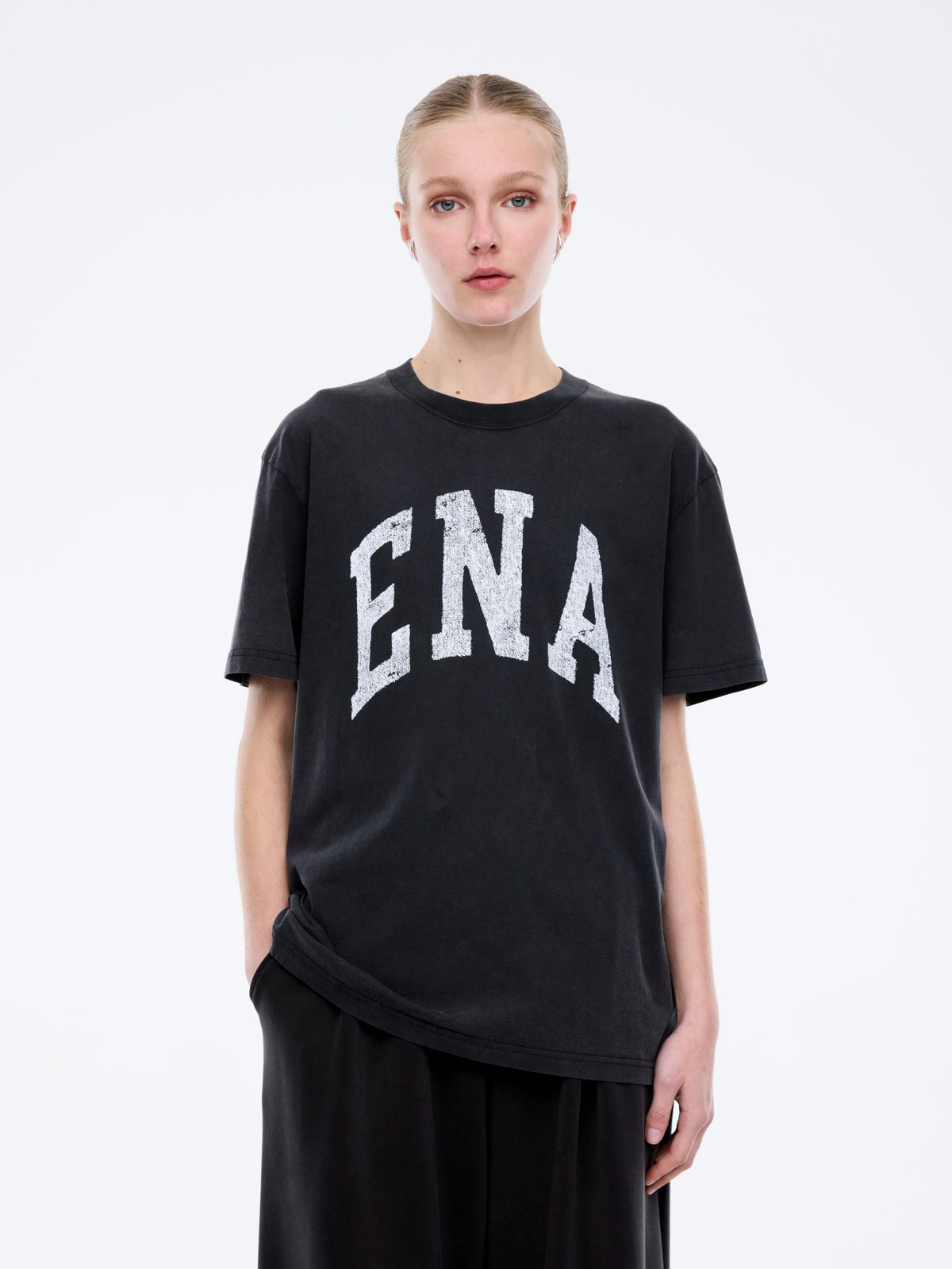Front detail of Jessie collegiate tee featuring distressed white ENA lettering on charcoal cotton