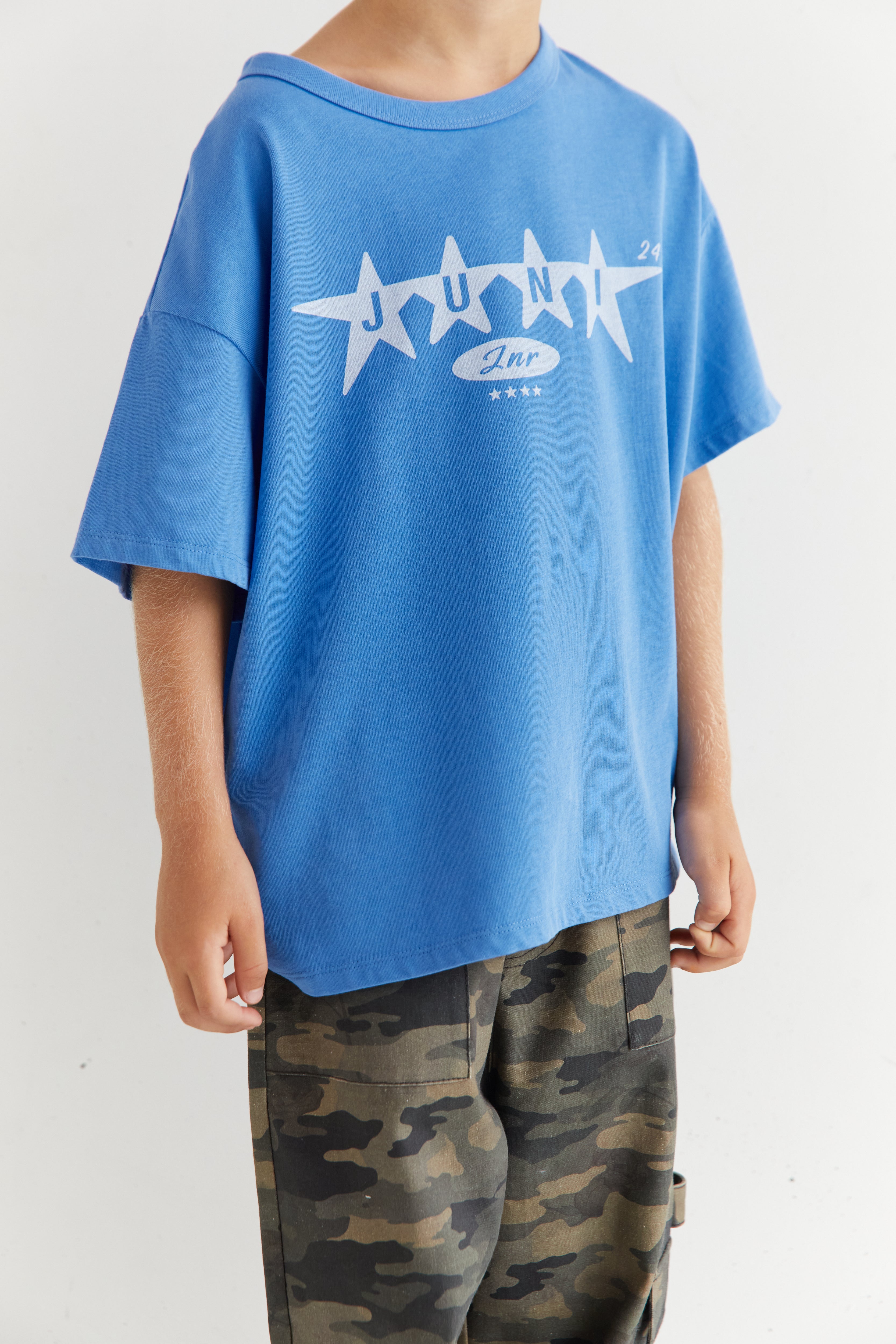 Front view close-up of azure blue Star Tee showing white star graphic and relaxed fit