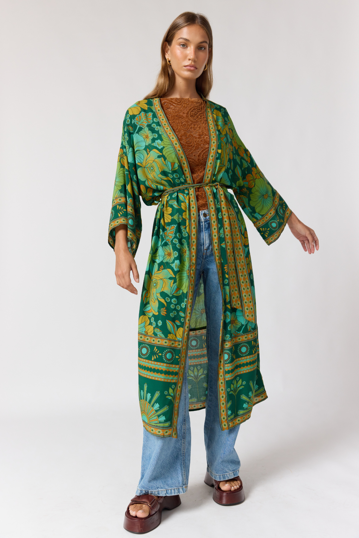 Close up detail of jade robe wide sleeves and contrast border trim