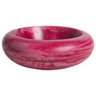 Side view of Jeanne Bowl in hot pink marbled resin with swirling magenta tones and chunky donut silhouette