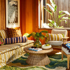 Cream marbled resin Jeanne Bowl styled on wicker coffee table in warm retro living room setting