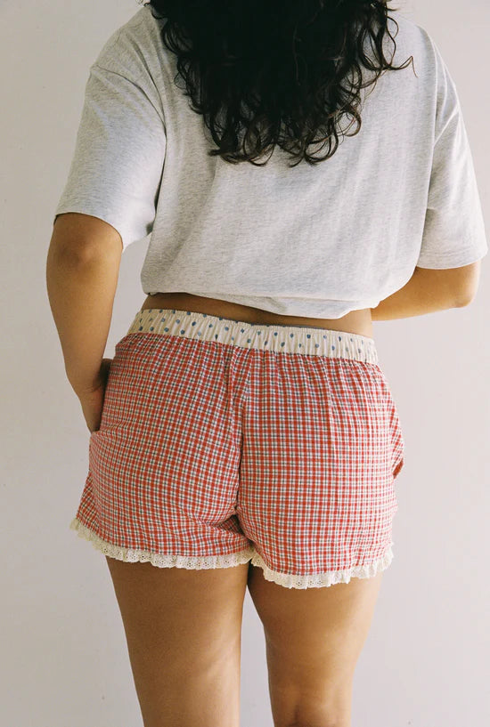 Juni shorts with red check pattern