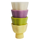 Stacked Joy Pedestal Bowls showing cream pink green and yellow color variations
