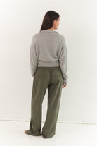 Back view of stone grey Kaia Zip Cardigan showing ribbed collar and cropped silhouette