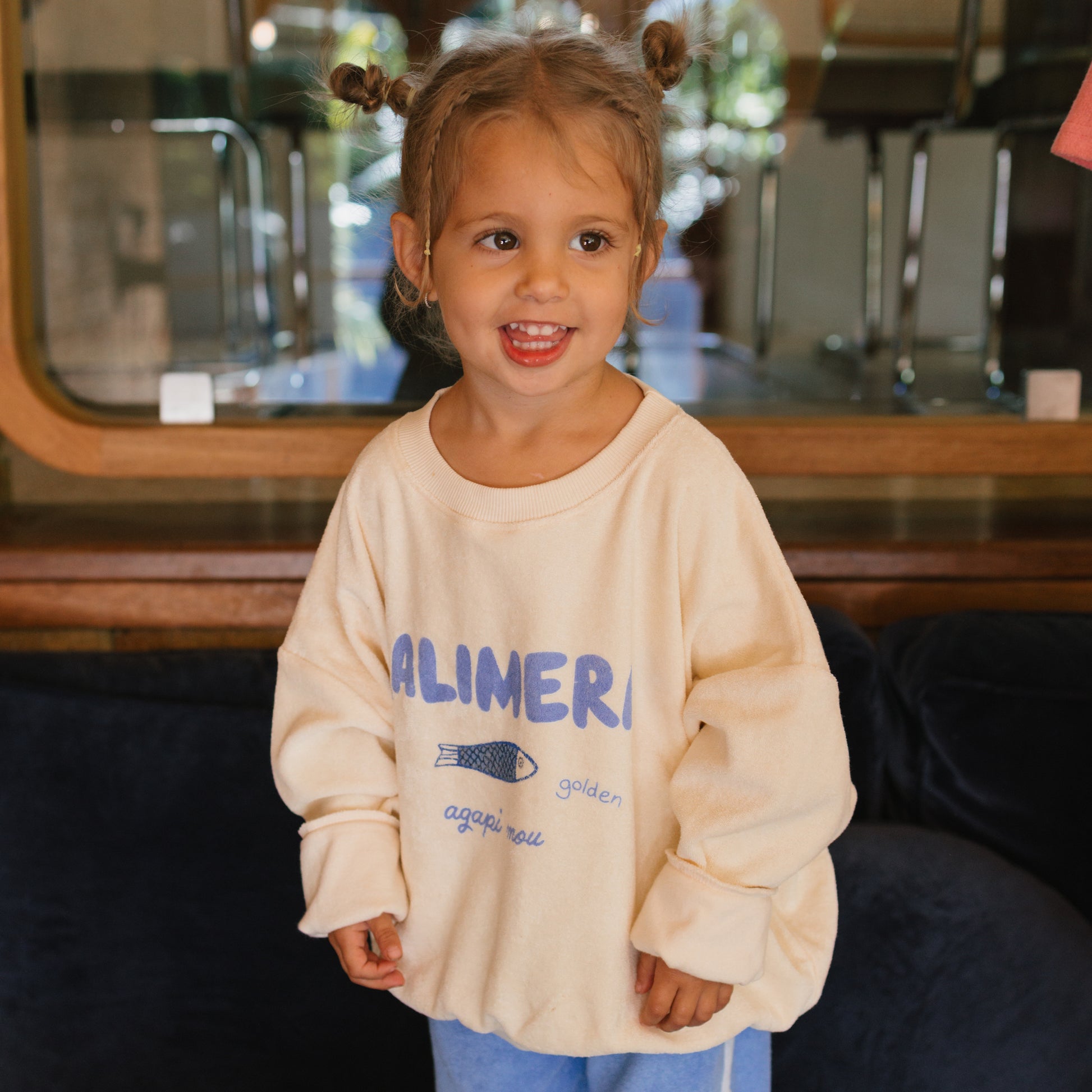 Young girl wearing the Kalimera Sweater - Buttercream | Golden Children