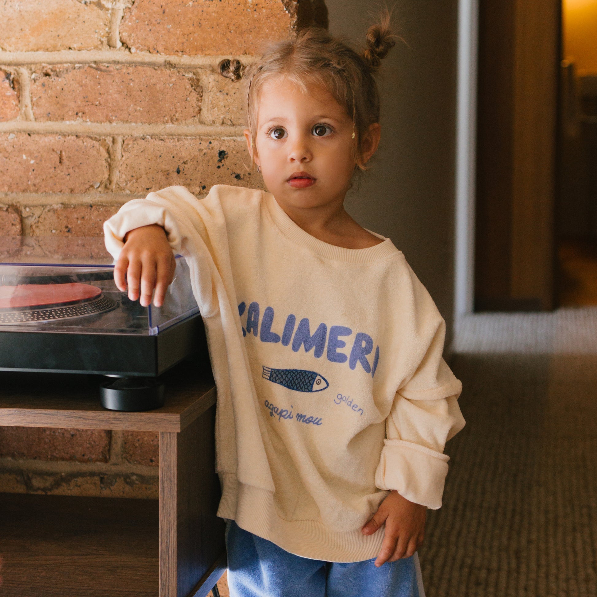 Girl wearing the Kalimera Sweater - Buttercream | Golden Children
