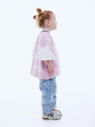 Side view of girl wearing Kids Lunar Jersey by Ena Pelly