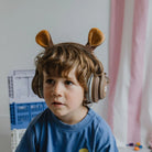 child wearing Kidyears Bear headphones by Kidywolf