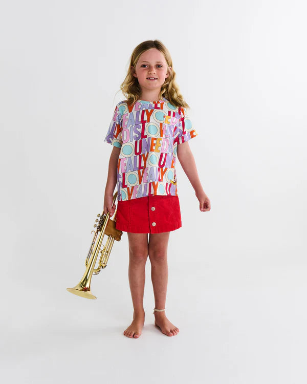 girl wearing Kip & Co x The Beatles All You Need Is Love Organic Cotton Kids T-Shirt