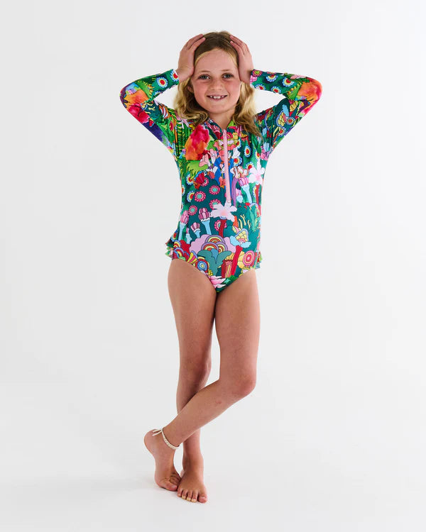girl standing up wearing the girls long sleeve swimsuit - 
Kip & Co x The Beatles Big Flower Dreamscape Long Sleeve Bathers