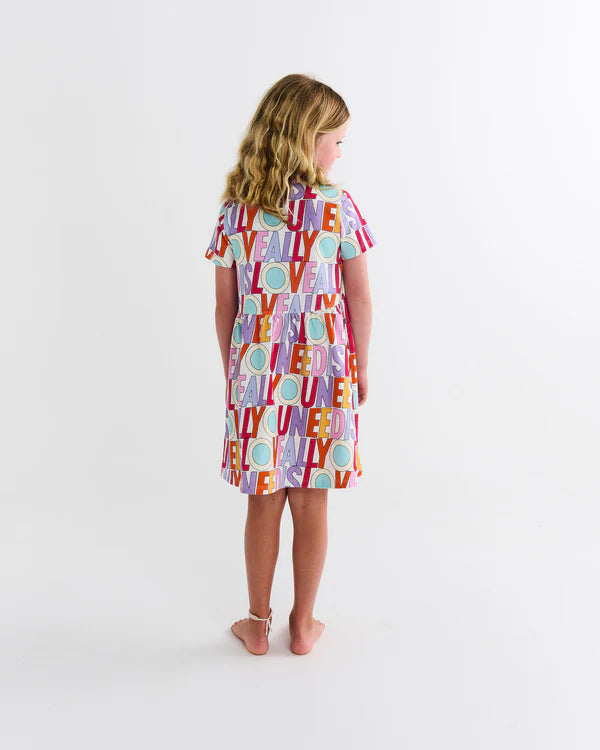 back of girl wearing Kip & Co x The Beatles All You Need Is Love Organic Cotton Everyday Dress