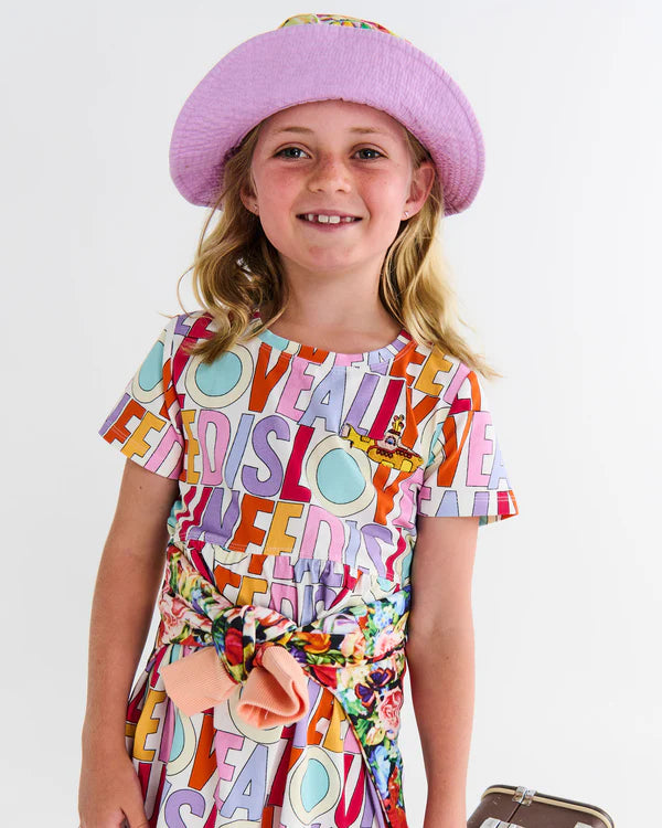 girl wearing "all you need is love" dress by kip & co