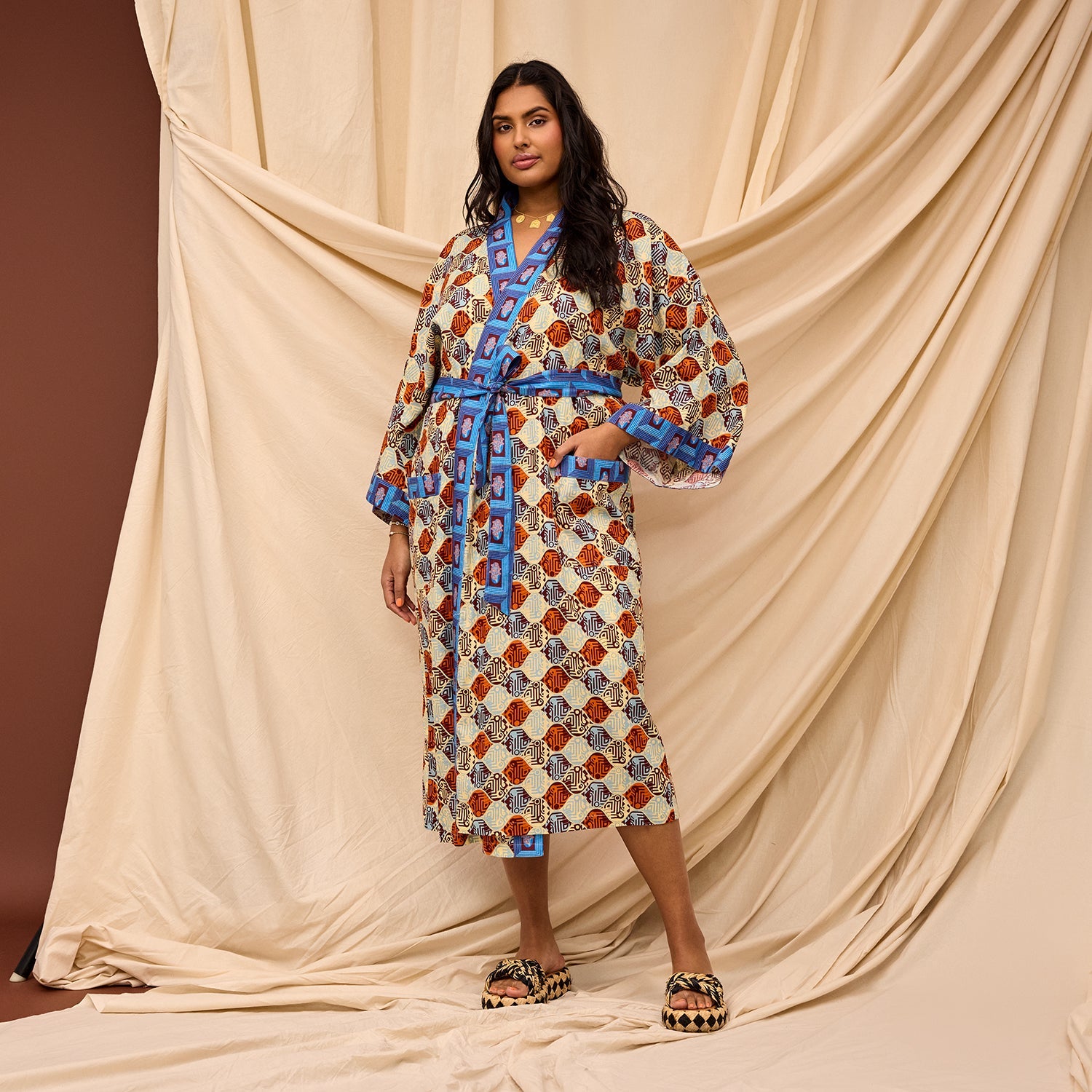 Model tying Koa Robe belt showcasing versatile styling options and fit