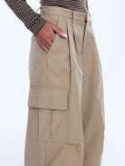Close-up detail of Lainey Cargo Pant sand colored fabric showing layered cargo pocket construction