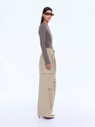 Side profile view of Lainey Cargo Pant in sand displaying wide leg fit and cargo pocket placement