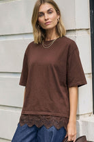 Close-up front view of chocolate brown Lacey Tee highlighting lace detail at bottom hem