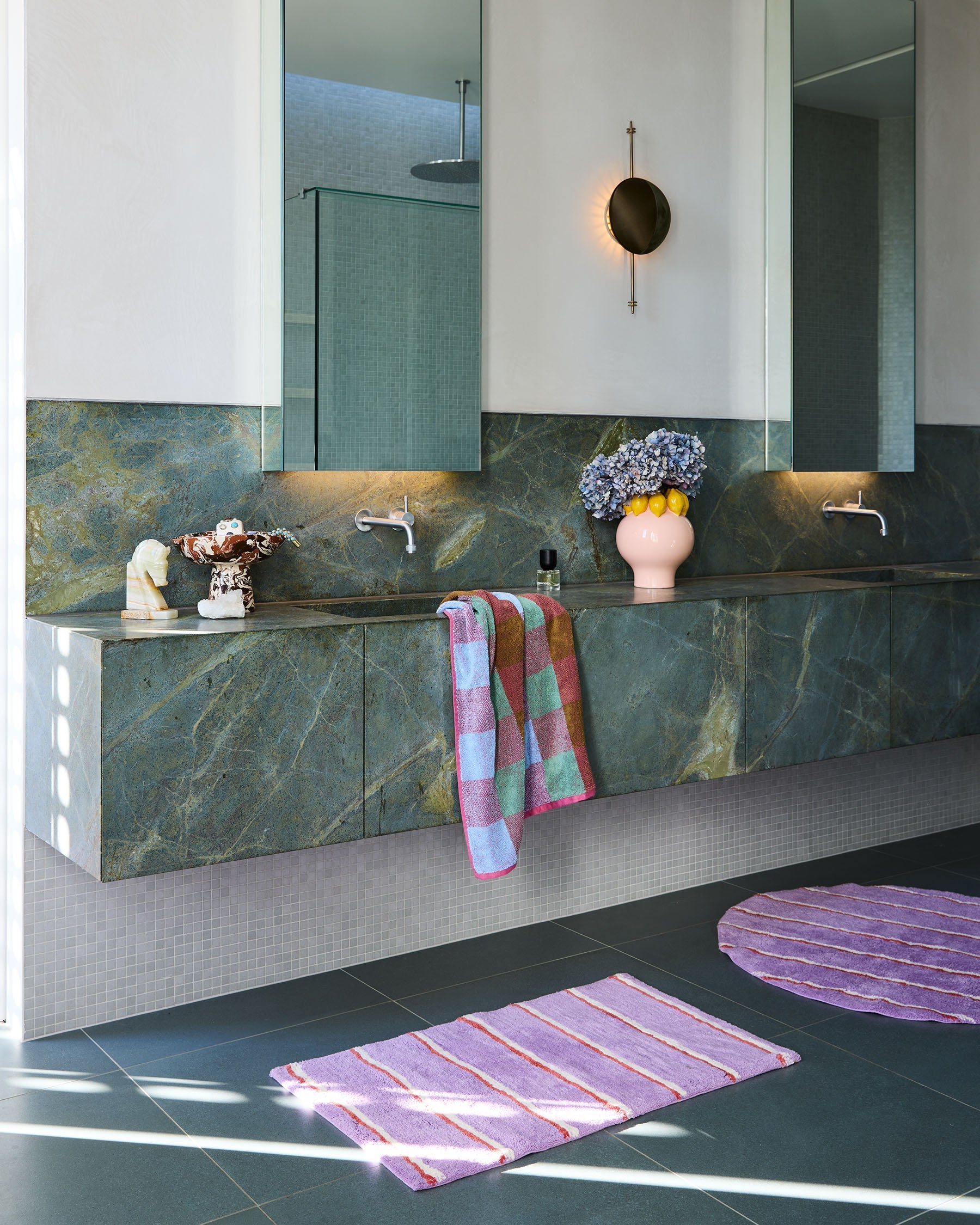 Modern bathroom featuring Lavender Field Stripe Bath Mat by Kip & Co on marble vanity floor with green cabinetry