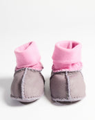 Front view of pair of lilac baby booties showing pink knit cuffs and gray leather construction